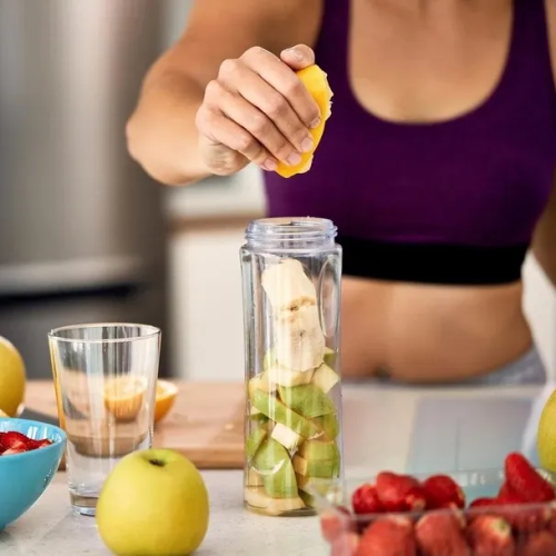 Fitness woman preparing healthy nutrition shake