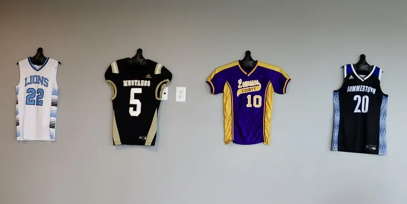 TOA Lawrenceburg sports team jerseys on wall